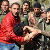 A citizen and soldiers carry a man who attempted to set himself ablaze in a suicide protest over unemployment outside the local government office in Kasserine, Tunisia, on Jan. 22, 2016. Tunisia declared a nationwide curfew on Friday after four days of protests and rioting over jobs and economic conditions, the interior ministry said. Tunisia imposes nationwide curfew amid spreading unrest