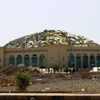 A sports hall is partially destroyed Tuesday by Saudi-led airstrikes in Sanaa. Despite war, sea risks, Ethiopians, Somalis flooding into Yemen: UN
