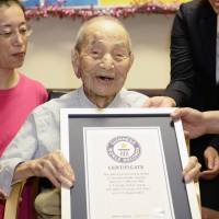 Yasutaro Koide, 112, holds a Guinness World Records certificate recognizing him as the world's oldest man last August in Nagoya. He died Tuesday. World's oldest man dies in Japan at 112