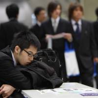 Enjoy it while it lasts: University students attend a job fair in Tokyo. The process of weighing up the options and then applying for jobs can be time-consuming for Japanese students in their last year of college. Graduates needn't be hostages to advance contracts