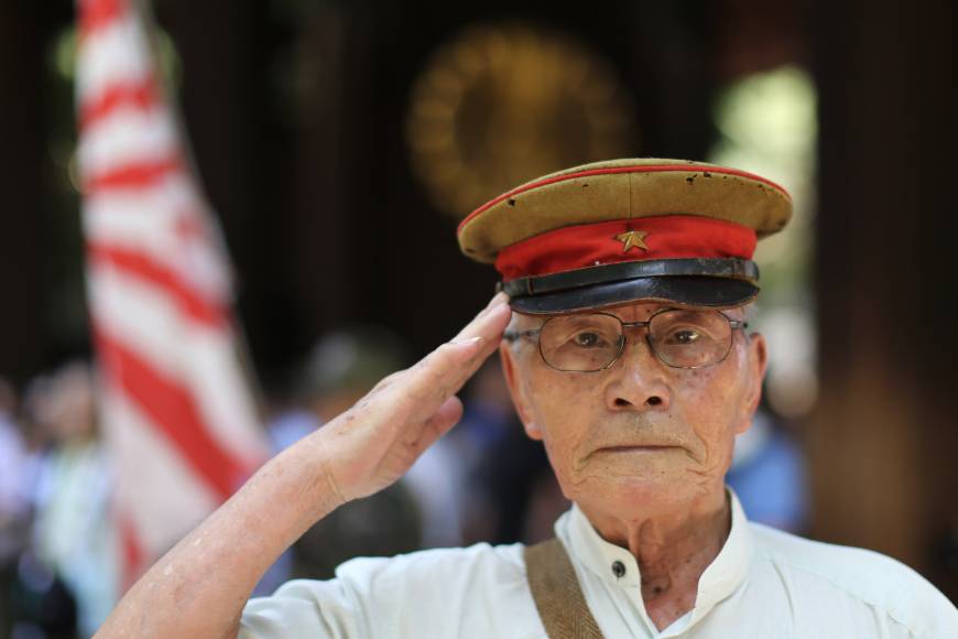 A former soldier salutes at Yasukuni Shrine in Tokyo on Aug. 15, the 70th anniversary of Japan