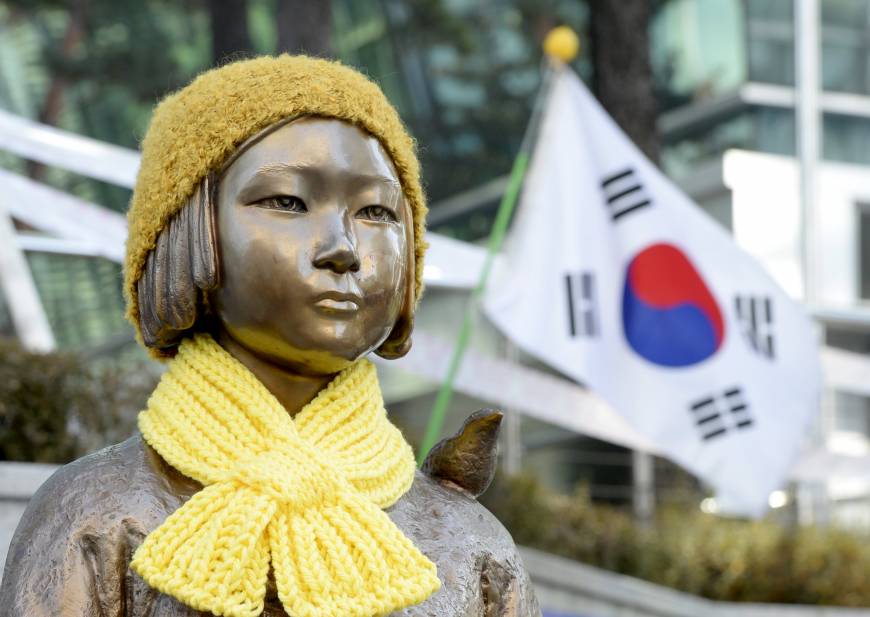 A statue of a girl representing sexual victims of the Japanese military stands in front of the Japanese Embassy in Seoul.