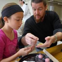 Sugar, no spice: Making Japanese sweets at a Kameya Yoshinaga in Kyoto workshop involves rolling and shaping small balls of sweet bean paste, in this case into cherry blossoms and butterflies. Workshops to keep the children sweet