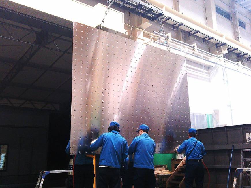 A steel plate, used in LCD-making equipment, being dried at Nishina Industrial Co.
