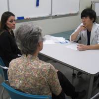 Stimulating patience: Christine Benson (left) and Ann Endo play a mother and daughter during a consultation with a Jikei University student. The Simulated Patients program aims to prepare medical students for dealing with foreign patients. Simulated patients pitch Japan's medical students cultural curve balls