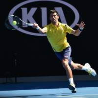Novak Djokovic plays a shot during his first-round win over South Korea's Chung Hyeon at the Australian Open on Monday. Match-fixing allegations overshadow first day of Australian Open