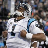 Panthers quarterback Cam Newton celebrates after scoring against the Cardinals during the third quarter of the NFC title game on Sunday in Charlotte, North Carolina. Panthers rout Cardinals to claim NFC title