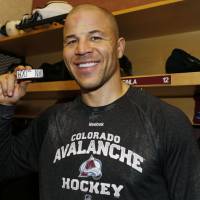 Colorado's Jarome Iginla holds up the puck in the locker room after he scored his 600th career goal against Los Angeles on Monday night. The Avalanche beat the Kings 4-1. Iginla scores 600th goal as Avalanche beat Kings