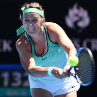 Victoria Azarenka plays a shot from Naomi Osaka in their third-round match at the Australian Open on Saturday. Azarenka won 6-1, 6-1. Osaka's run stopped by Azarenka
