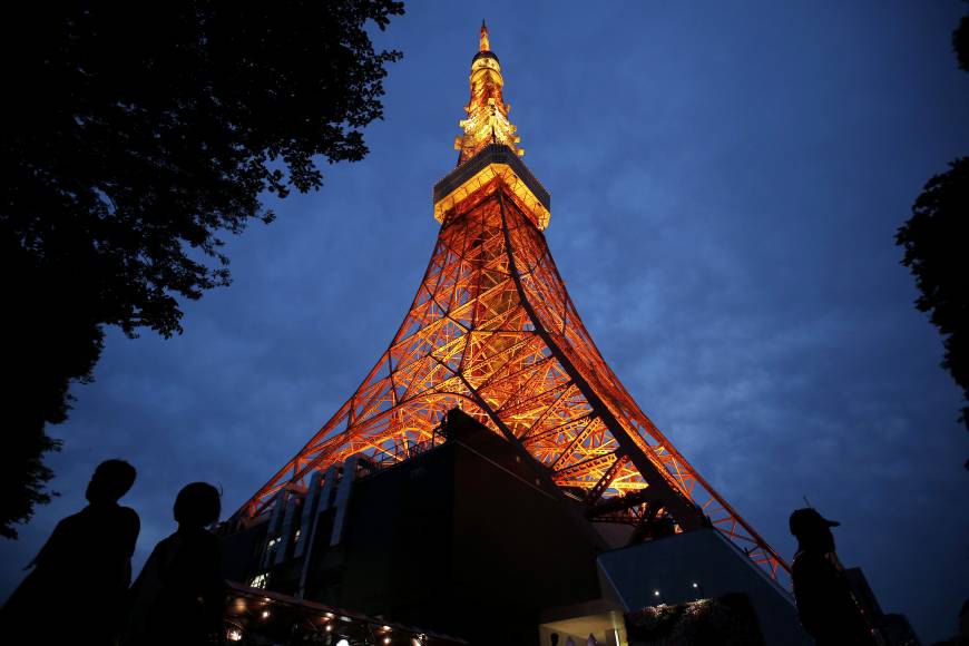 Eiffel of the East: Visitors walk under an illuminated Tokyo Tower at night. Going off the beaten track, skip dinner for two in the city and take your date for an overnight trip to the nearby hot spring resort town of Hakone for a nature-filled Valentine