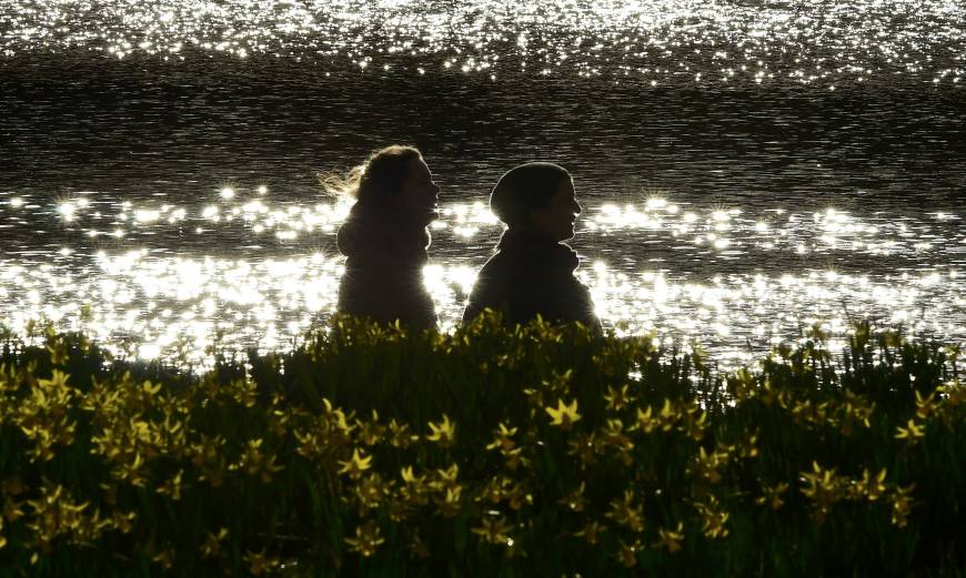 Flower promenade: A couple strolls through blooming daffodils in St. James Park, London. For a unique date experience, attend a workshop together on megalith carving at Southwark Cathedral.