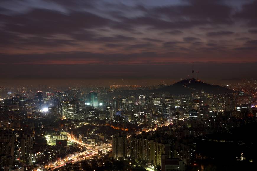 Evening cityscape: A view of buildings around the N Seoul tower, a landmark in a rapidly growing city. While you