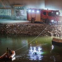 Fatal crash: Swedish police examine the wreckage of a car crash that killed the four members of British indie band Viola Beach and their manager in Stockholm on Feb. 13. U.K. band members killed after car crashes into Swedish canal