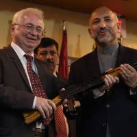 Russian Ambassador to Afghanistan Alexander Mantytskiy (left) hands over an AK-47 rifle to Afghan National Security Adviser Hanif Atmar during a ceremony at a military airfield in Kabul on Feb. 24, 2016. Russia delivered 10,000 Kalashnikovs to the Afghan government on the same day, with officials saying they were for the fight against terrorism. Russia gives Afghanistan 10,000 Kalashnikov assault rifles