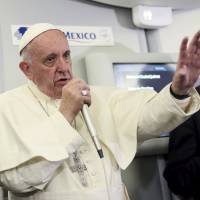 Pope Francis gestures during a meeting with the media onboard the papal plane while en route to Rome Wednesday. Church has no place for bishops who transfer suspect pedophile clerics, pope says