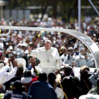 Pope Francis waves to the crowd after celebrating Mass at San Cristobal de las Casas, Mexico, Monday. Pope hits Mexico indigenous exploitation, says they 'have much to teach us'