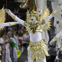Performers from the Estacio de Sa samba school parade during Carnival celebrations at the Sambadrome in Rio de Janeiro Sunday. Rio turns to samba to swat away gatecrashing Zika fears