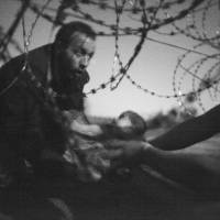 World Press Photo of the Year and Spot News, 1st prize singles, World Press Photo Awards (Warren Richardson — “Hope for a New Life”) A man passes a baby through the fence at the Serbia/Hungary border in Roszke, Hungary, Aug. 28. World Press Photo award goes to unpublished image of migrants