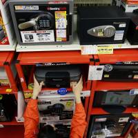 Safes are sold at a Shimachu outlet in Tokyo’s Adachi Ward on Feb. 19. Surge in safe sales, ¥10,000 notes reflects sagging faith in economy