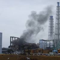 The wrecked No. 3 reactor building at the Fukushima No. 1 nuclear power plant is seen on March 21, 2011, 10 days after a quake and tsunami knocked out power to the plant. At left is reactor No. 2 and at right is reactor No. 4. Tepco admits it should have declared meltdowns at Fukushima plant much earlier