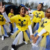 Members of a school cheer team practice dance moves before marching in the North Carolina MLK Black History Month Parade on Feb. 6 in Durham, North Carolina. In Japan, don't just celebrate black history, <em>be</em> black history