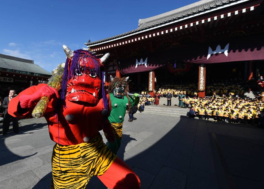 Two parents of kindergarten students dress up as demons, while the children throw beans to ward away evil spirits and bring good luck, as part of the annual Setsubun Festival at Sensoji Temple in Tokyo on Wednesday. Japan catches good luck fever — ‘Setsubun’ 2016