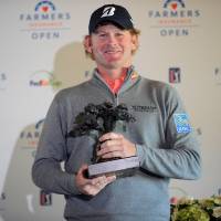 Brandt Snedeker poses with the winner’s trophy following his Farmers Insurance Open victory at Torrey Pines on Monday. Snedeker wins Farmers Insurance Open