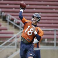 Denver Broncos QB Peyton Manning throws a pass during practice at Stanford, California, on Wednesday. The Broncos will play the Carolina Panthers in Super Bowl 50 on Sunday. Peyton hopes to go out on top like boss Elway