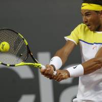 Rafael Nadal plays a shot from Spanish compatriot Nicolas Almagro in their second-round match at the Rio Open on Thursday. Nadal won 6-3, 7-5. Nadal, Ferrer make quarters in Rio