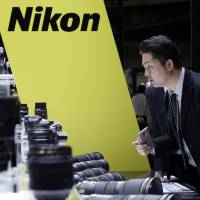 An attendee looks at the lineup of Nikon Corp. Nikkor lenses displayed at the CP+ Camera and Photo Imaging Show in Yokohama last month. Nikon, Casio in short sellers' sights as tech pessimism abounds