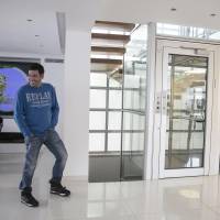 Convicted con man Gilbert Chikli smiles during an interview at his home in the port city of Ashdod, Israel, in November. China laundering foreign criminals' cash, probe finds