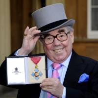 British comedian Ronnie Corbett poses with his medal after he received the honor Commander of the Order of the British Empire (CBE) from Britain's Queen Elizabeth II during an investiture ceremony at Buckingham Palace in central London on Feb. 16, 2012. Corbett, one of Britain's most successful comedians best known for The Two Ronnies, his double-act show with Ronnie Barker, has died aged 85, his publicist said on Thursday. British comedy great Ronnie Corbett dies aged 85