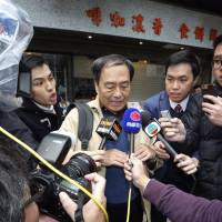 Bookseller Lee Bo (center) speaks to media near his home in Hong Kong on Friday. The book editor whose disappearance nearly three months ago rattled civil liberties advocates in Hong Kong and sparked international concern returned home from the Chinese mainland Thursday, police said. Rising China risk tarnishes Hong Kong business hub luster