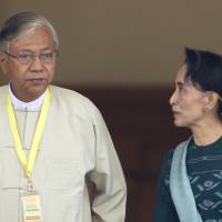 Htin Kyaw, left, newly elected president of Myanmar, walks with National League for Democracy leader Aung San Suu Kyi, right, at Myanmar's parliament in Naypyitaw, Myanmar, on March 15. Suu Kyi to control Myanmar government, party spokesman says