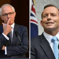 This combo image shows current Australian Prime Minister Malcolm Turnbull (left) at a news conference in Canberra last September and former Prime Minister Tony Abbott speaking to the media in Canberra on Feb. 9. Australian leader clashes with predecessor over record
