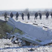 Emergencies Ministry members work at the crash site of a Boeing 737-800 Flight FZ981 operated by Dubai-based budget carrier FlyDubai, at the airport of Rostov-On-Don, Russia, Sunday. Black boxes badly damaged in Russia plane crash; data retrieval in doubt