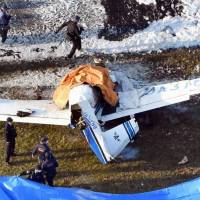 The wreckage of a Mooney M20c single-engine aircraft that crashed on a taxiway at Yao Airport in Osaka Prefecture on Saturday is seen in this photo. Professional negligence suspected in fatal plane crash in Osaka