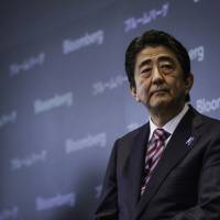 Steering the ship: Prime Minister Shinzo Abe’s high approval ratings may come from voters who are looking for a confident leader in troubled times. 'Teflon Abe' gets high marks despite unpopular policies