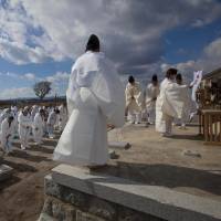 Brief return: Evacuees from towns inside the nuclear exclusion zone surrounding the damaged Fukushima No. 1 plant participate in a memorial ceremony in the abandoned town of Namie in February 2012. Five years on, Fukushima evacuees voice lingering anger, fear and distrust