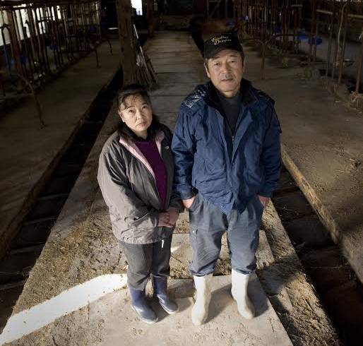 Kenichi Hasegawa and his wife visit his now-vacant dairy farm in Iitate village in December 2011.