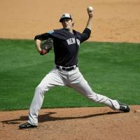 Yankees closer Andrew Miller pitches against Atlanta at spring training on Wednesday in Kissimmee, Florida. Miller was struck by a line drive on the pitch and suffered a broken right wrist. Yankees lose closer Miller to broken wrist from line drive