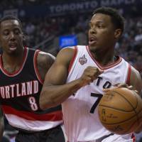 Toronto’s Kyle Lowry drives on Portland’s Al-Farouq Aminu in first-half action on Friday in Toronto. The Raptors defeated the Trail Blazers 117-115. DeRozan seals victory at foul line