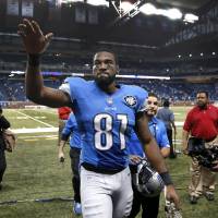 Lions receiver Calvin Johnson waves to fans as he leaves the field following a victory over the Dolphins on Nov. 9, 2014, in Detroit. Lions superstar Johnson announces retirement