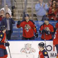 Florida's Jaromir Jagr (center) stands as the crowd cheers during the second period against Boston on Monday. Jagr passed Gordie Howe to move into third on the NHL career points list. Jagr moves past Howe on career points list