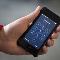 An iPhone is seen in Washington in February. The FBI said Wednesday that it will not publicly disclose the method that allowed it to break into a locked iPhone used by one of the San Bernardino attackers, saying it lacks enough technical information about the software vulnerability that was exploited. FBI won't reveal how it hacked killer's locked iPhone, leaving Apple in dark on security vulnerabilities