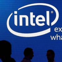 Shadows are cast near the Intel logo at the 2015 Computex exhibition in Taipei last June. Intel Corp said it would cut 12,000 jobs globally, or 11 percent of its workforce, as the company moves away from its traditional business of selling chips used in personal computers. Intel to shed 12,000 workers amid PC sales slump, shift in direction