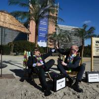 Activists act as clients of an offshore company during a protest of nongovernmental organizations Oxfam and Transparency International in front of the European Commission headquarters in Brussels, on Tuesday. Apple, GE, other U.S. giants stashed $1.4 trillion in offshore tax havens: Oxfam
