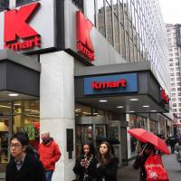 Pedestrians pass a Kmart location in New York in 2011. Sears Holdings Corp. is announcing Thursday, that it will close 68 Kmart stores and 10 Sears stores as it struggles to restore profitability. After 'challenging' holiday season, Sears to shut 78 stores this summer