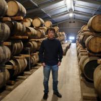 Ichiro Akuto shows off barrels of whisky at his distillery, Venture Whisky Ltd., in Chichibu, Saitama Prefecture. His single malts sell for as much as ¥100,000 a bottle. Japanese whisky at ¥100,000 a bottle driving rice farmers to the drink