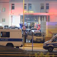 Police vehicles park in front of the Artemis brothel as police officers, tax fraud investigators and customs officers search the premises of the brothel in Berlin, on Wednesday. 900 German authorities raid huge, Hells Angels-linked Berlin brothel, bust six